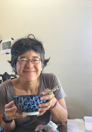 author picture holding blue ramen bowl with chopsticks